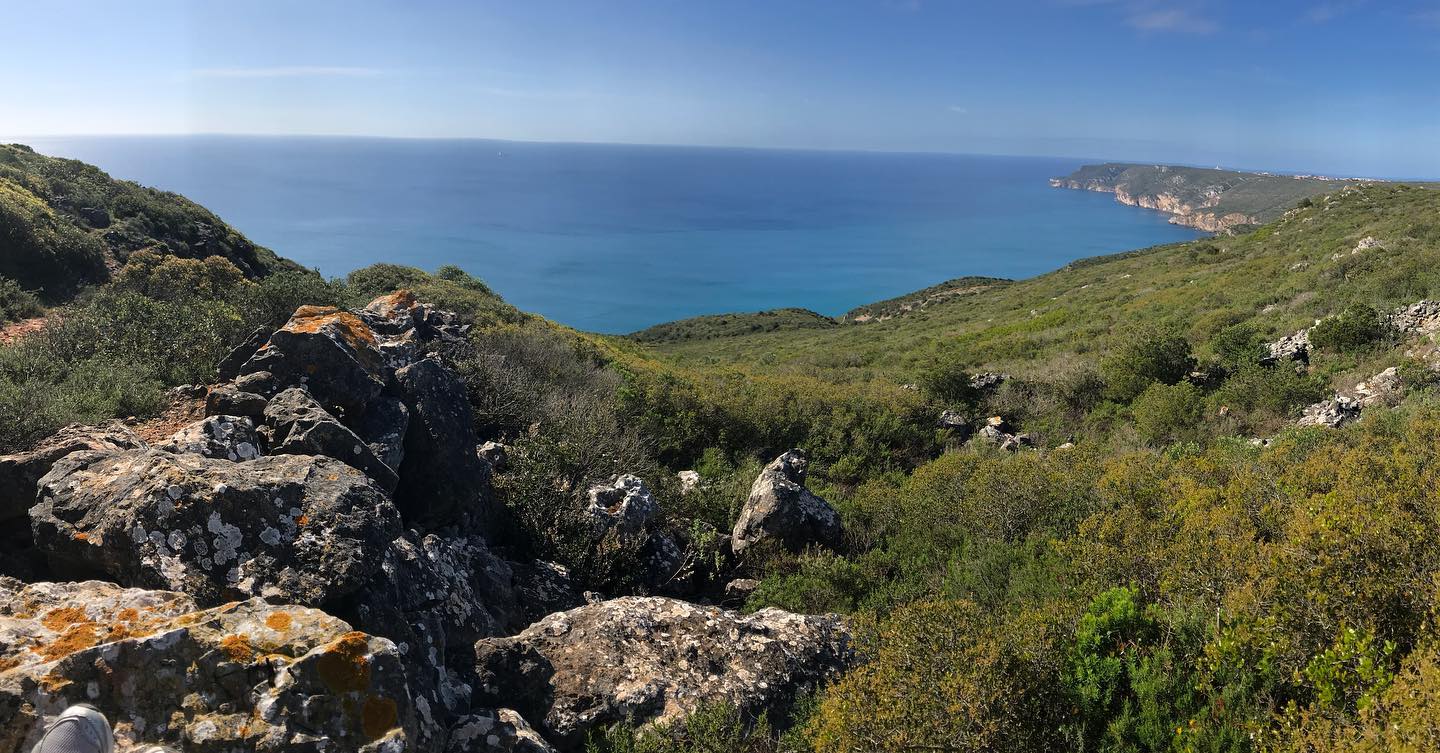 Panoramic view from Serra da Arrábida hiking trail, limestone rocks and Mediterranean scrubland overlooking turquoise coast