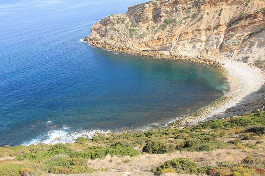 Secluded pebble cove and turquoise sea, Serra da Arrábida Natural Park, Portugal