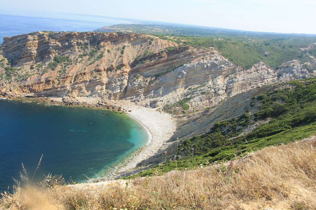 Panoramic view of Cabo Espichel north coastline with limestone cliffs and turquoise cove, Setúbal Peninsula, The Untold Weekend Portugal